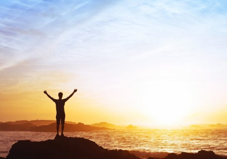 freedom concept, man with raised hands, silhouette