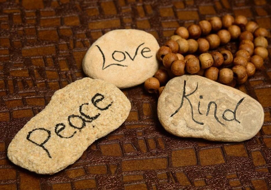 peace, love and kindness words on rocks for world peace