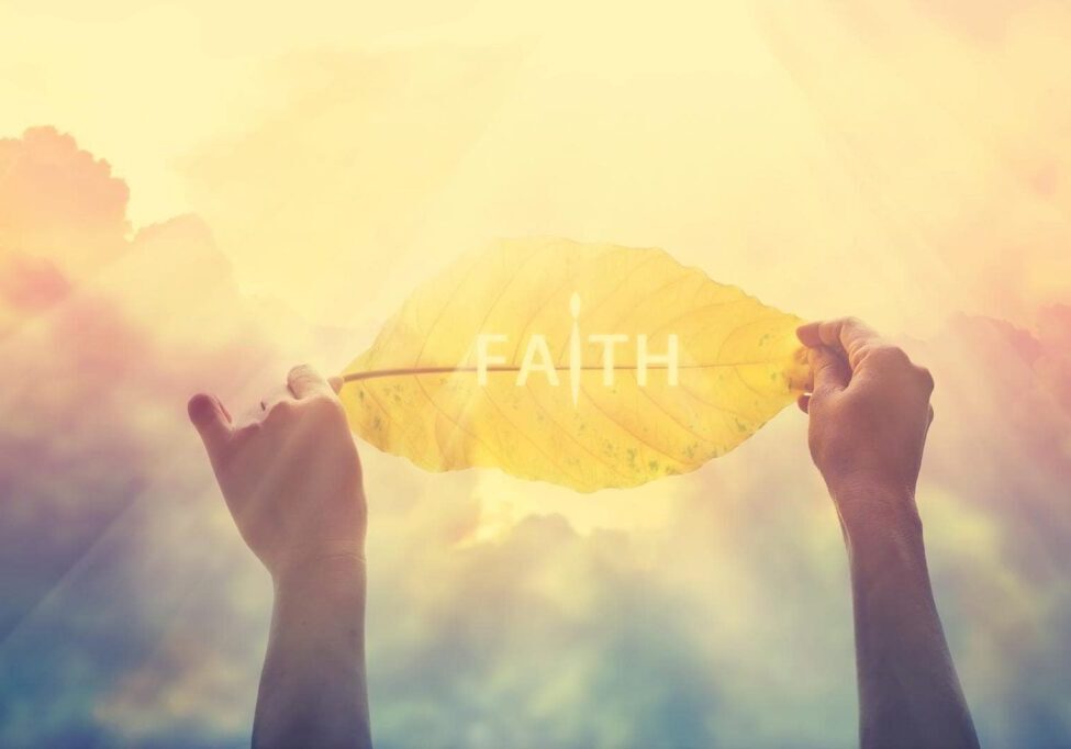 abstract, holding a yellow leaf in the clorful sky of faith, vintage color tone and soft focus